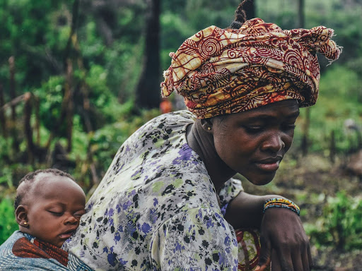 woman carrying baby on back