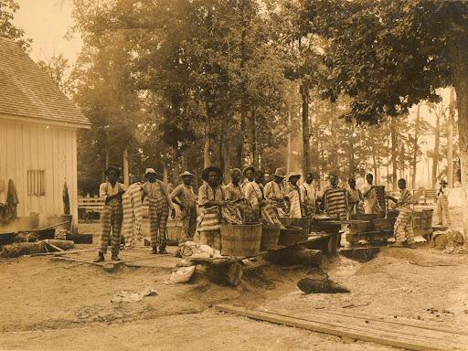 black men in striped prison suits