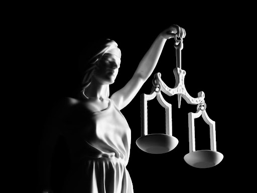 blindfolded lady justice holding a balance scale