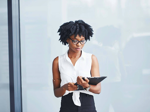 black woman in glasses with notepad