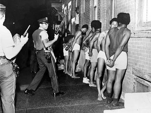 black men lined up against the wall 