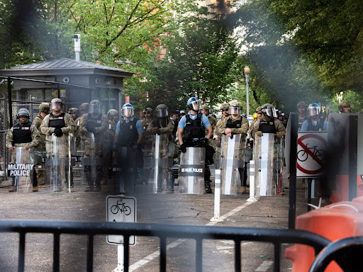 police gathered in a line with riot gear