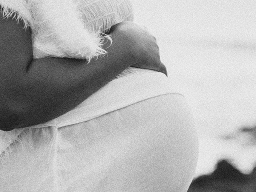 pregnant person holding their belly in a black and white photo
