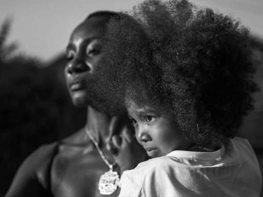 black woman holding a child in her arms