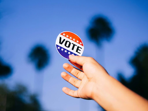 person holding up vote button