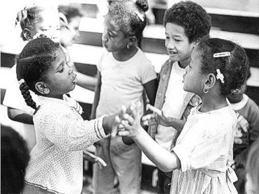 children standing together in a circle playing