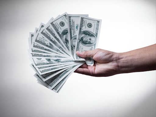 person holding 100 us dollar bills