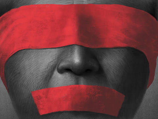 person with red tape over their mouth