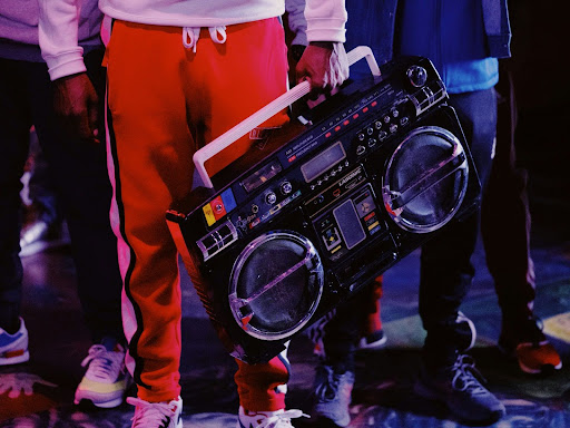 man in red jacket holding black dj controller