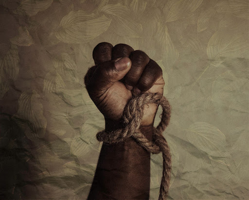 raised closed fist with rope wrapped around the wrist
