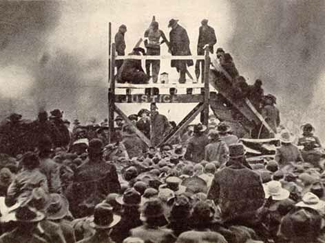 people on a platform in front of a crowd