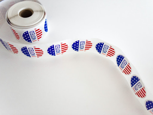 roll of stickers that say voted on them