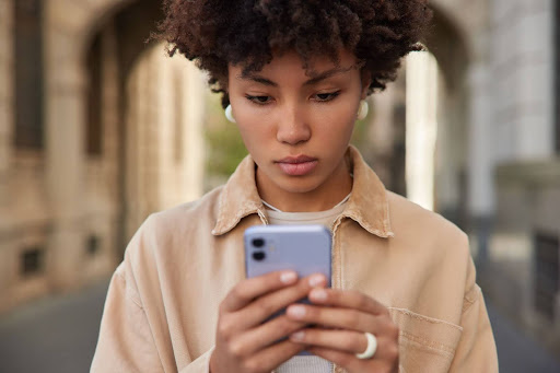 woman reads sms message on smartphone 