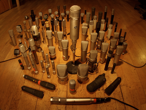 different types of microphones on a wooden floor 
