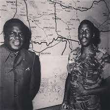 two black men standing in front of a map