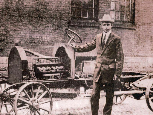 man standing by an automobile
