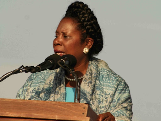 sheila jackson lee standing in front of microphones