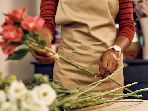 black florist arranging fresh flowers 