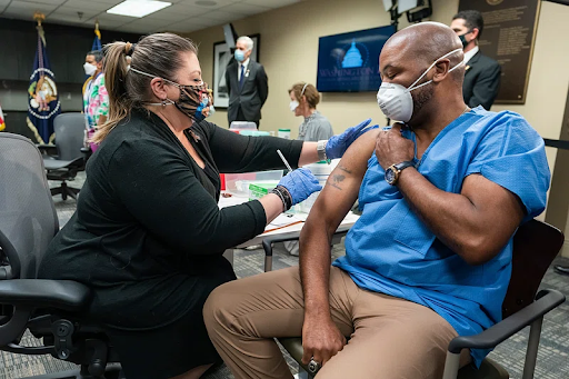 nurse providing a patient a vaccine