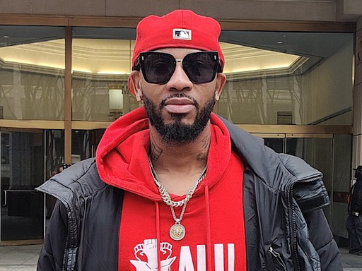 christian smalls with red hoodie and sunglasses on