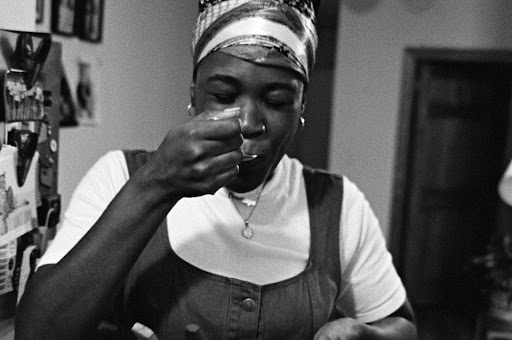 black woman sipping from a spoon