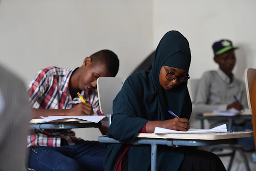 students sitting down working on a test