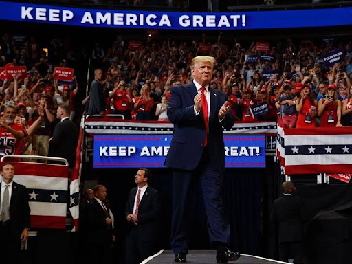 trump in front of keep america great sign