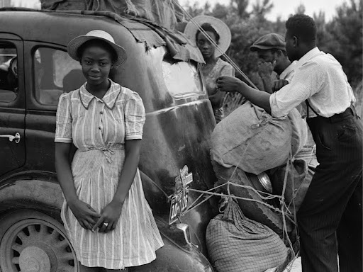 migrant workers standing outside of the car 