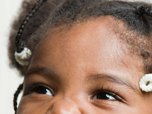 a little girl making a funny face with her mouth open