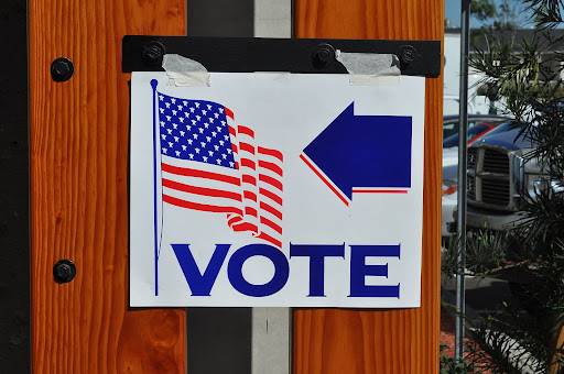 sign showing where polling location is that says vote 