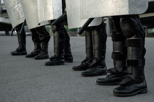 group of riot police staff in black boots standing