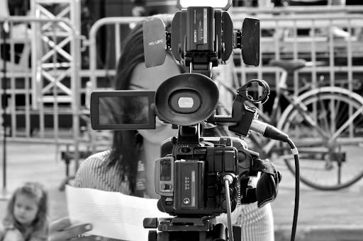 woman standing behind a camera