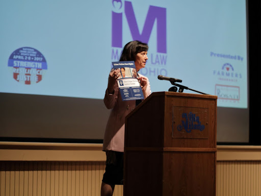 carthy harper lee speaking at a podium