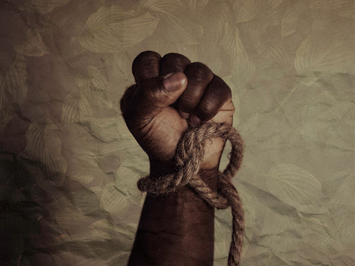raised fist with a rope tied around the wrist 