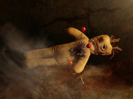voodoo doll with pins in the heart 