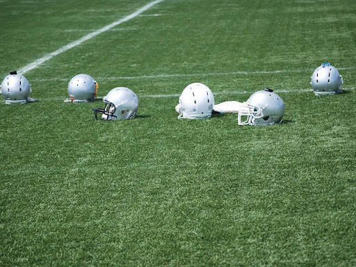 football helmets laying on the field