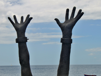 Statue of hands with shackles on wrist