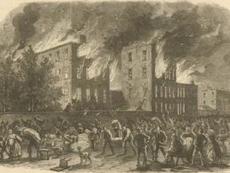 building burning with mob surrounding the building 