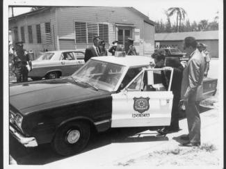 Puerto Rico Governor Roberto Sanchez Vilella greets a PRPD officer