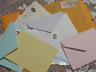 pile of envelopes with stamps