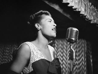 billie holiday singing into a microphone