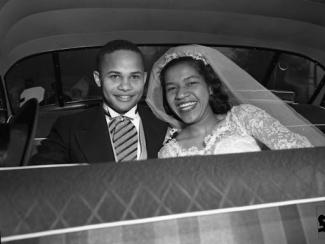 Black couple in a car on their wedding day