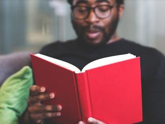 black man reading a book 