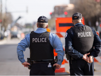 Police officers in front of road closures