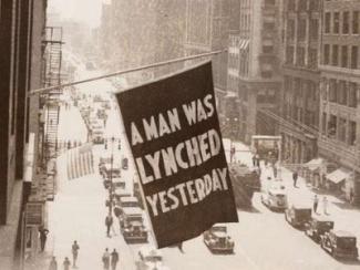 flag saying a man was lynched yesterday hanging from the window of naacp headquarters