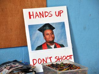 ferguson protest poster that reads hands up don't shoot