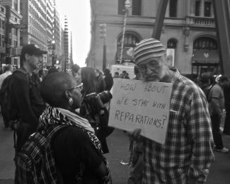 Man with reparations sign