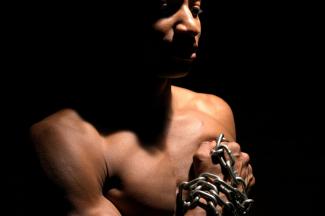 Man with chains on his arms
