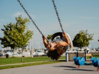little girl in a tire swing