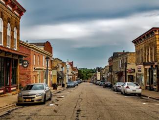 cars parked along a street with businesses